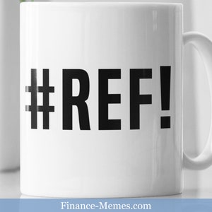 May include: White ceramic mug with a black hashtag and the word "REF!" printed on it.