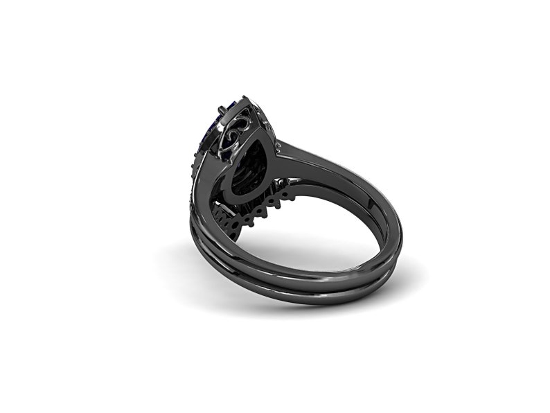May include: Black engagement ring set with a pear-shaped center stone and a halo of smaller stones. The ring has a black band and a matching band for stacking. The design features intricate details and a dark, elegant aesthetic.