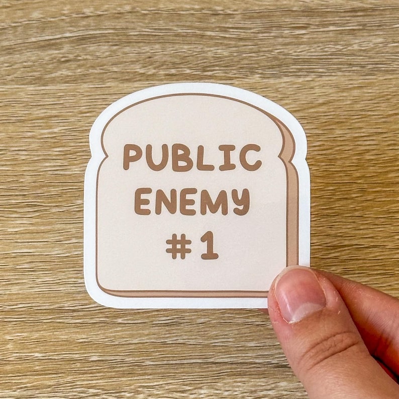 Funny sticker of piece of bread with the text "Public Enemy #1" for anyone with celiac or gluten intolerance. Gluten free
