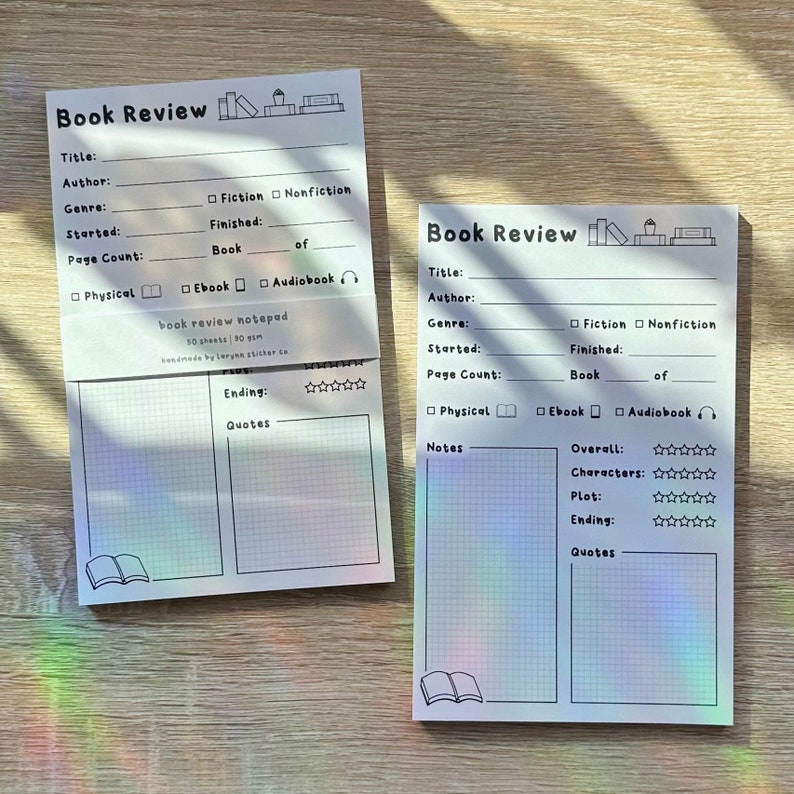 May include: Two white book review notepads with a grid pattern. The notepads have a black book icon and the text "Book Review" at the top. The notepads have sections for title, author, genre, started, finished, page count, physical, ebook, audiobook, notes, overall, characters, plot, ending, and quotes. The notepads have a five-star rating system for overall, characters, plot, and ending.