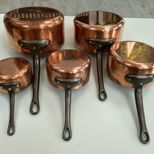 Precioso juego de 5 cacerolas francesas de cobre vintage de Les Cuivres de Faucogney: apenas usadas, con revestimiento de estaño y asas robustas remachadas.