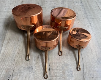 Vintage French Set of 4 Copper Saucepans, Metaux Ouvres SA in Vesoul, in good condition, never used, tin lined, inc instructions from maker.
