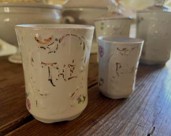 2 Antique French White Gilded Porcelain Pot/Jar - marked The (Tea) and Poivre (Pepper) with pretty faded pink/blue/green floral design.