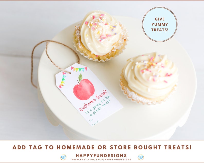 May include: A printable tag with a red apple and the text "Welcome back! It's going to be a great year!"  The tag is attached to a string and is hanging from a cupcake with white frosting and colourful sprinkles. The text "Give Yummy Treats!" is written in a circle above the cupcakes.