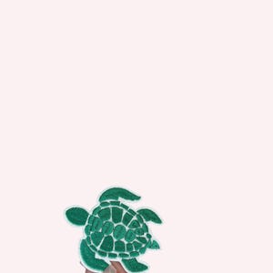 May include: A green embroidered turtle patch with a white border. The turtle design features a detailed shell pattern and is set against a light pink background. This patch is suitable for clothing or accessories.