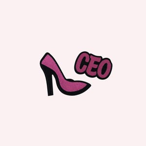May include: A pink high-heeled shoe patch with a black heel and trim, next to a patch with the word "CEO" in black letters. The patches have a glittery texture and are set against a light pink background.