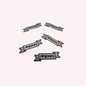 May include: Five embroidered patches featuring a white rectangular banner with a black border and pink ribbon ends. The text I HEART BOOKS is stitched in black, with a small black heart symbol replacing the word heart in each patch design.