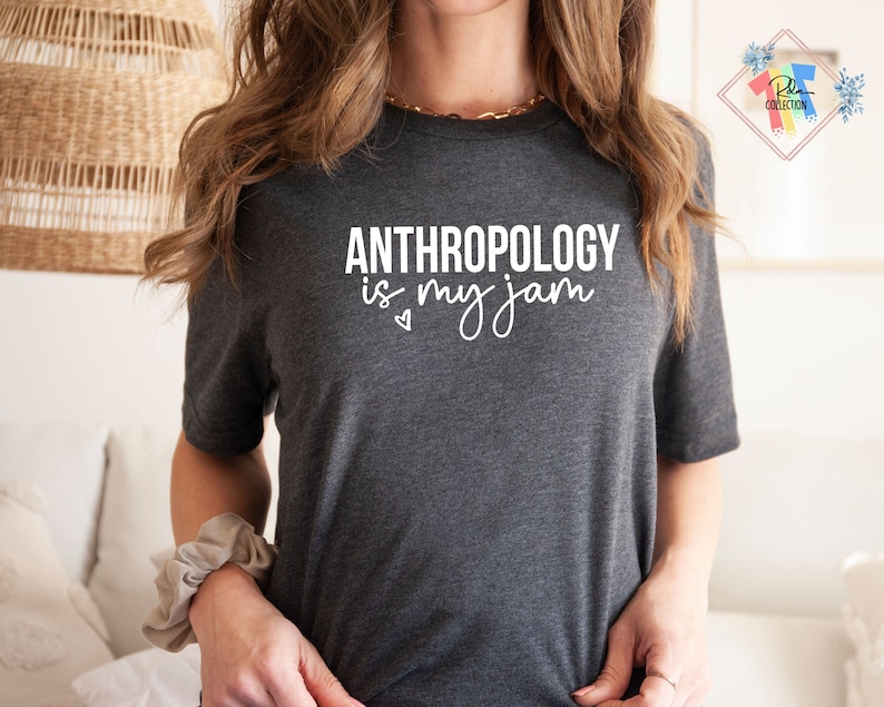 May include: A dark grey t-shirt with the text "ANTHROPOLOGY is my jam" in white lettering. A small heart is printed below the text.