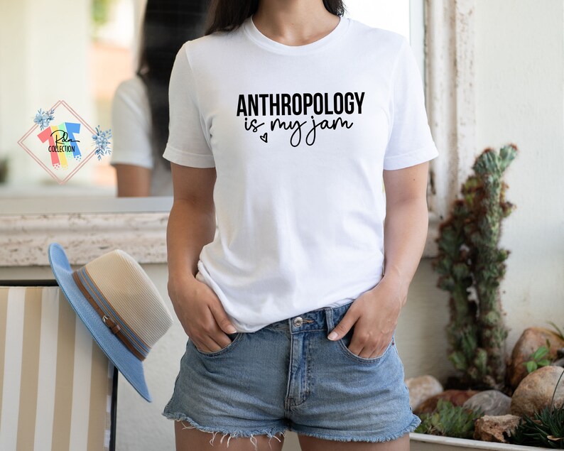May include: White t-shirt with black text that reads "Anthropology is my jam" with a small heart symbol.