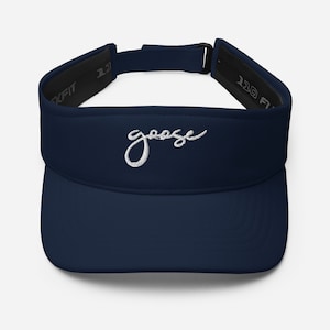May include: Navy blue visor with the word "goose" embroidered in white script. The visor has a curved brim and an adjustable strap. The interior features a black sweatband for comfort. The Flexfit brand is visible on the side.