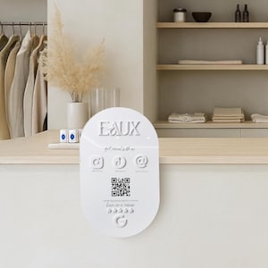 May include: A white sign with the word "EAUX" at the top, featuring social media icons and a QR code. The sign also includes the phrase "get social with us" and a rating system with stars.