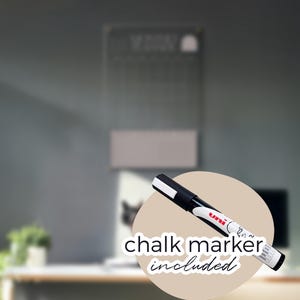 May include: A black and white chalk marker with the text "chalk marker included" on a beige circle. The marker is in front of a blurred background with a chalkboard and a desk.