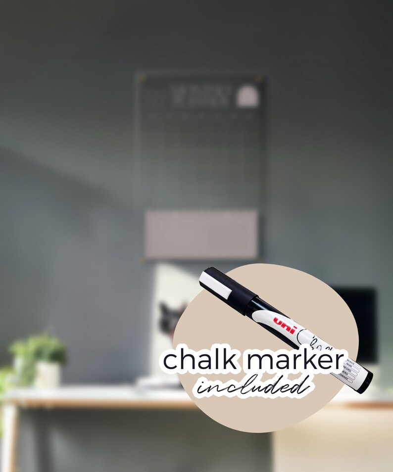 May include: A black and white chalk marker with the text "chalk marker included" on a beige circle. The marker is in front of a blurred background with a chalkboard and a desk.