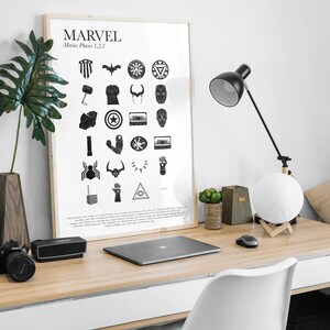 May include: A black and white poster with the word "MARVEL" and the text "Movies Phases 1, 2, 3" at the top. The poster features a grid of 24 black and white icons representing characters and objects from the Marvel Cinematic Universe.
