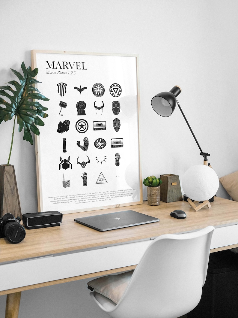 May include: A black and white poster with the word "MARVEL" and the text "Movies Phases 1, 2, 3" at the top. The poster features a grid of 24 black and white icons representing characters and objects from the Marvel Cinematic Universe.