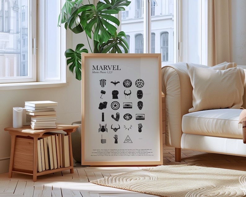 May include: A framed black and white poster with the word "MARVEL" and the text "Movies Phases 1, 2, 3" at the top. The poster features a grid of 24 black and white icons representing characters and objects from the Marvel Cinematic Universe.