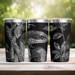 May include: Three stainless steel travel mugs with a black background and a white snake illustration. The snake design wraps around the mug, with leaves and branches. The mugs have a silver rim and lid.
