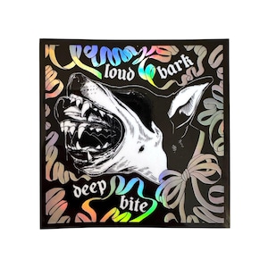 May include: Square sticker with a black background. It features a monochrome illustration of a dog's head with an open mouth, teeth bared. The words "loud bark" and "deep bite" are written in a rainbow holographic font.