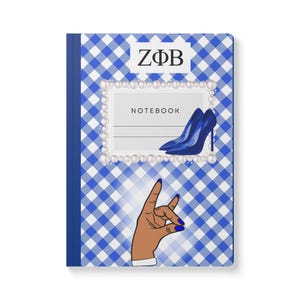 May include: Notebook with a blue and white gingham pattern. The cover features the letters ZΦB, a pair of blue high heels, and a hand gesture with blue nail polish. The word "NOTEBOOK" is also visible.