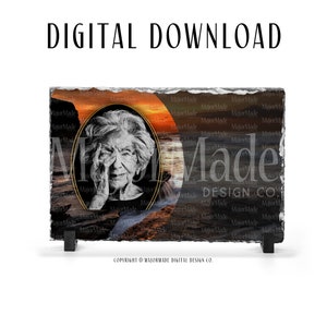 May include: A digital download of a black and white photo of an older woman with gray hair, set against a sunset over the ocean. The photo is in a gold oval frame and the background is a black slate with the text "MajorMade DESIGN CO."