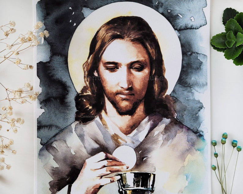 Puede incluir: Una pintura de acuarela de Jesucristo sosteniendo una hostia y un c&aacute;liz. La pintura est&aacute; hecha en tonos de marr&oacute;n, blanco y azul, con un halo de luz alrededor de la cabeza de Jes&uacute;s.