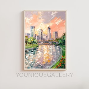 May include: A painting of a cityscape with a river in the foreground. The city is painted in a light, impressionistic style with a soft pink and purple sky. The river is a light blue with reflections of the city and sky. The painting is framed in a white frame.