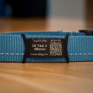 May include: A blue dog collar with a black tag that says "Tag4MyPet" and has a QR code that says "SCAN ME". The tag also says "ID TAG # dBzoao" and "www.idtag.link".