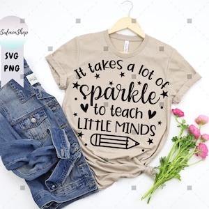 May include: A tan t-shirt with the text "It takes a lot of sparkle to teach little minds" in black lettering. A black pencil drawing is below the text.