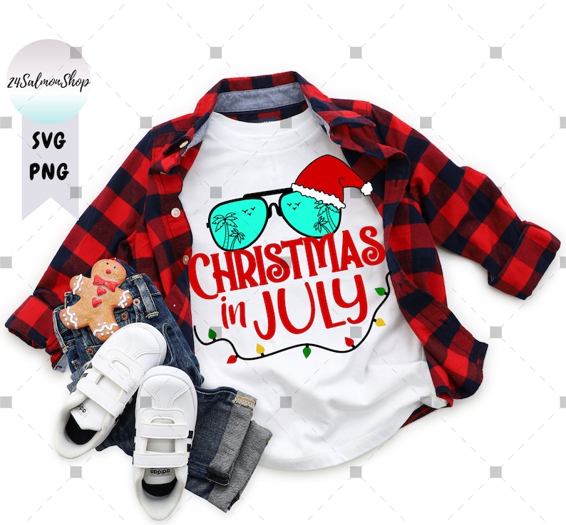 May include: White t-shirt with a red and white Santa hat wearing sunglasses with palm trees and the text "Christmas in July".