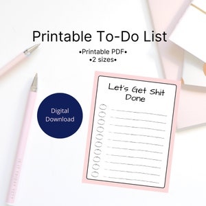 May include: A printable to-do list with the text "Let's Get Shit Done" and a series of checkboxes. The list is bordered in pink and includes the text "Printable To-Do List" and "Digital Download". Two pink pens are also visible.