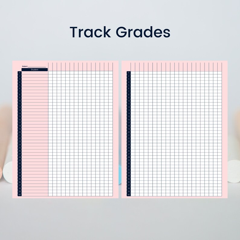 May include: Two-page spread of a pink grade tracking sheet with a grid pattern. The left page has a dark blue column for student names, and the right page is blank. The words "Track Grades" are at the top.