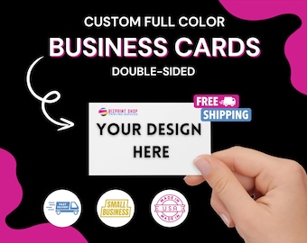 May include: A white business card mockup with the text "YOUR DESIGN HERE" and "BIZPRINT SHOP PRINTING SERVICES" in black text. The card is being held by a hand against a black background with pink accents. The text "CUSTOM FULL COLOR BUSINESS CARDS DOUBLE-SIDED" is at the top of the image. The text "FREE SHIPPING" is in a blue box with a white truck icon. There are three circular icons at the bottom of the image: one with a truck and the text "FAST DELIVERY", one with the text "SMALL BUSINESS", and one with the text "MADE IN USA MADE IN".