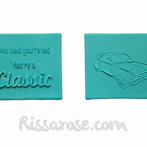 May include: Two turquoise blue rubber stamps. One stamp has the text "Who said you're old You're a Classic". The other stamp has a line drawing of a classic car.