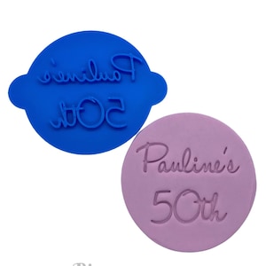May include: Two round silicone cake stamps, one blue and one purple. The blue stamp says "Pauline's 50th" and the purple stamp says "Pauline's 50th".