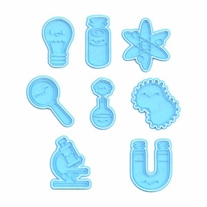 May include: A set of nine blue plastic cookie cutters shaped like science-themed objects, including a light bulb, a test tube, an atom, a magnifying glass, a beaker, a bacteria, a microscope, and a horseshoe magnet. The cutters are on a white background.