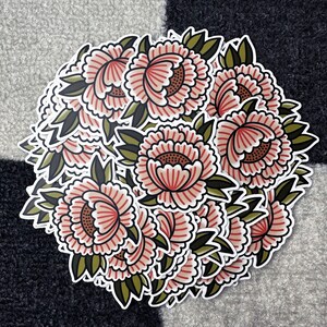 May include: A collection of floral stickers featuring pink and green flowers with intricate details. The stickers are arranged in a circular pattern, creating a visually appealing design.