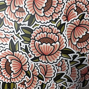 May include: A sheet of stickers featuring pink and white peonies with green leaves. The stickers are arranged in a random pattern.