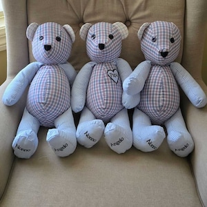 May include: Three handmade teddy bears with blue and pink plaid bodies and striped arms and legs. Each bear has a black stitched nose and eyes. The bears are personalized with names on their feet and a heart that says "Papa".