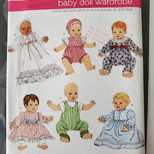 May include: Simplicity sewing pattern number 2704 for a baby doll wardrobe. The pattern includes five different outfits for dolls sized 30.5-35.5 cm, 40.5-45.5 cm, and 51-56 cm. The outfits include a white dress with lace trim, a red and white gingham jumpsuit, a blue and white floral dress, a green and white striped jumpsuit, and a light blue dress with lace trim.
