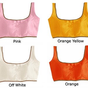 May include: Four sleeveless tops in different colors: pink, orange yellow, off white, and orange. Each top has a brown trim around the neckline and bottom.