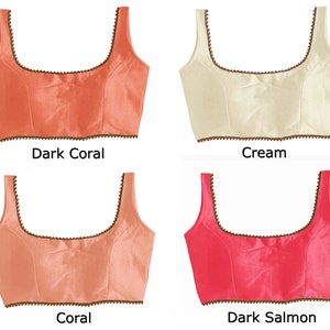 May include: Four different colored sleeveless tops with a square neckline and a beaded trim. The colors are dark coral, cream, coral, and dark salmon.