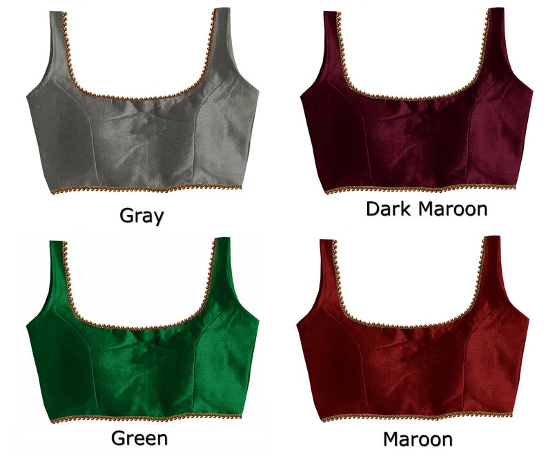 May include: Four different colored sleeveless blouses with a gold trim. The colors are gray, dark maroon, green, and maroon.