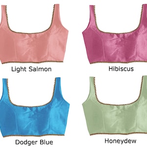 May include: Four different colored satin fabric crop tops with a beaded trim. The colors are light salmon, hibiscus, dodger blue, and honeydew.