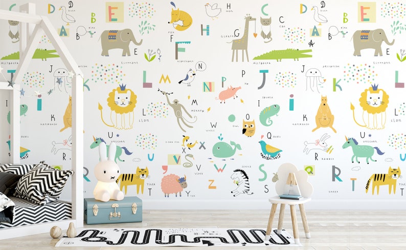 May include: A white wall with a colourful alphabet mural featuring animals and letters. The mural includes a lion, elephant, giraffe, kangaroo, and other animals. The letters are in a variety of colours and fonts. The mural is perfect for a child's room.