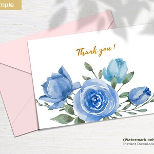 May include: A white card with a blue watercolor floral design and the text "Thank you!" in gold lettering. The card is surrounded by a pink envelope.