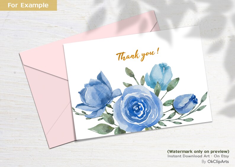 May include: A white card with a blue watercolor floral design and the text "Thank you!" in gold lettering. The card is surrounded by a pink envelope.