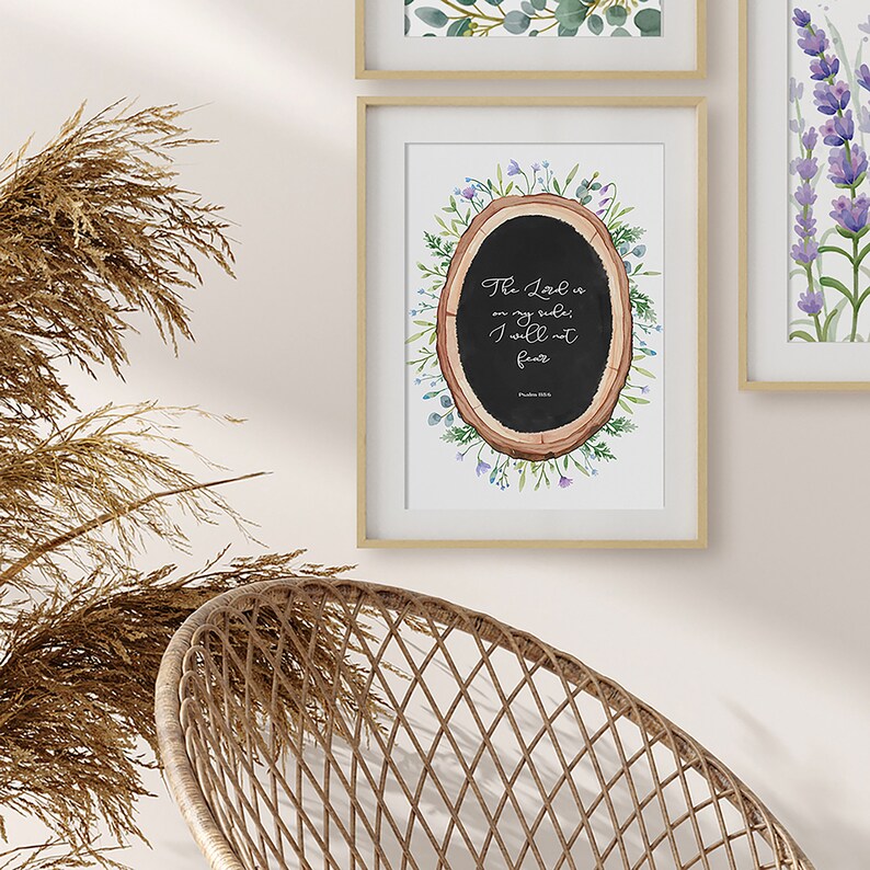 May include: A framed print featuring a watercolour illustration of a tree stump with a black chalkboard inside. The chalkboard displays the text "The Lord is my shepherd; I will not fear" and "Psalm 23:4". The tree stump is encircled by watercolour flowers and leaves.