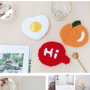 May include: Four colorful handmade coasters with different designs. The coasters are made of yarn and feature a heart-shaped fried egg, a round orange, a speech bubble with the word "Hi", and a round persimmon.