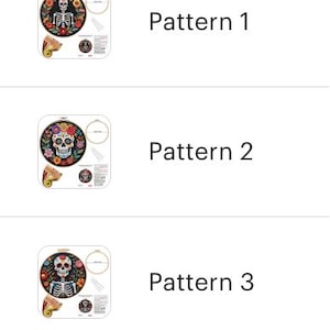 May include: A selection of Day of the Dead embroidery patterns. Each pattern features a sugar skull or skeleton design surrounded by flowers. The patterns are displayed in embroidery hoops, with additional craft supplies visible.