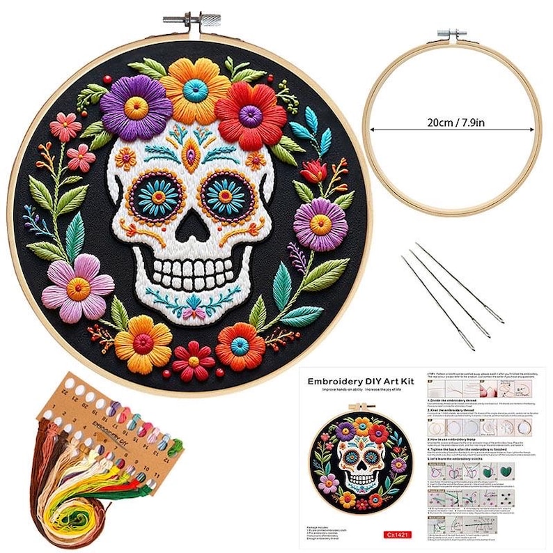 May include: An embroidery DIY art kit featuring a Day of the Dead skull design. The skull is surrounded by colorful flowers in a black hoop. The kit includes embroidery floss, needles, and a 7.9-inch (20cm) hoop.